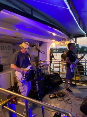 A group of people playing music on a boat.