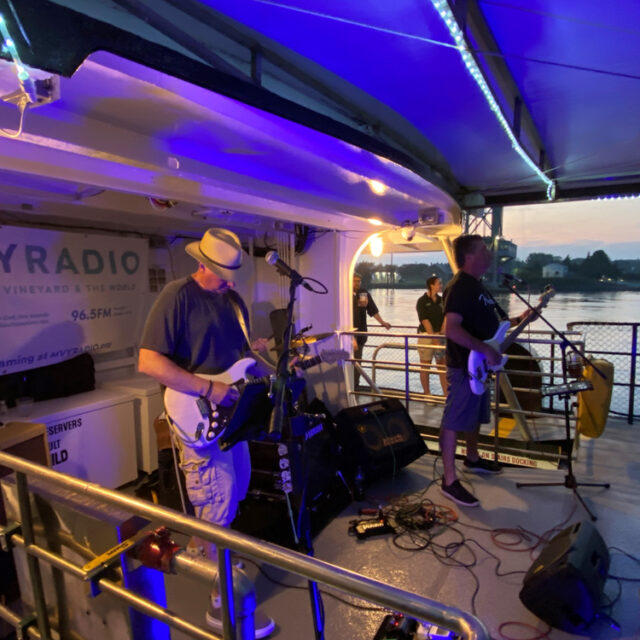 A group of people playing music on a boat.