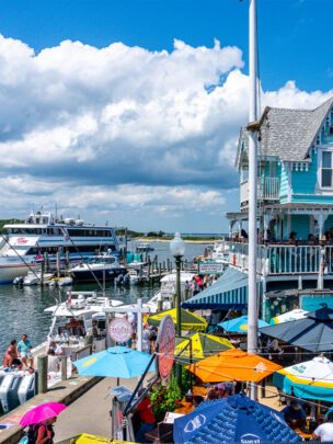Harbor view image with ferry and colorful umbrellas and building