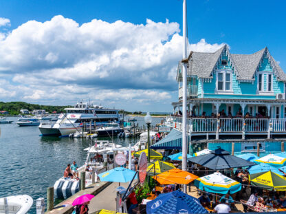 Harbor view image with ferry and colorful umbrellas and building